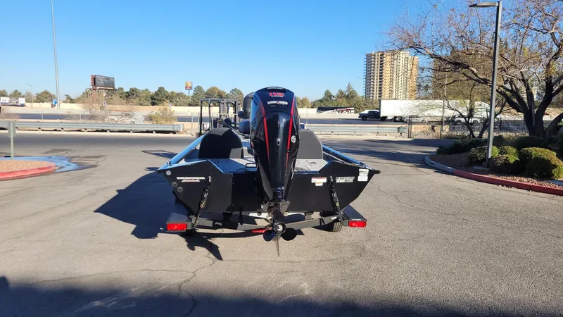 Slide: The Image of 2025 Tracker Pro Team 190 boat on trailer in parking lot, rear view. - 4