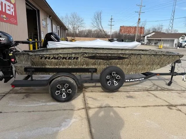 The Image of 2025 Tracker Grizzly 1650 T Prairie Wings Edition boat on trailer, parked outdoors. - 0