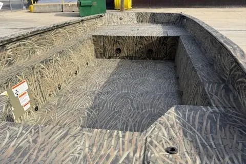 Slide: The Image of 2025 Tracker Grizzly 1650 T Prairie Wings Edition boat with camouflage interior design. - 2