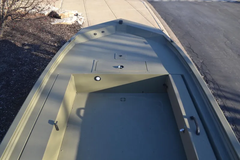 Slide: The Image of 2025 Tracker Grizzly 1654 T Sportsman boat, olive green, empty deck view. - 4