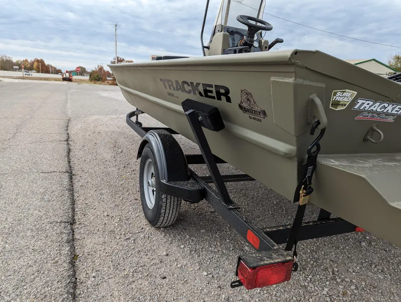Slide: The Image of 2025 Tracker Grizzly 1860 CC boat on trailer, parked on a paved road. - 3