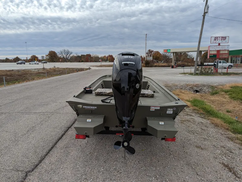 Slide: The Image of 2025 Tracker Grizzly 1860 CC boat on a trailer, parked on a roadside. - 4
