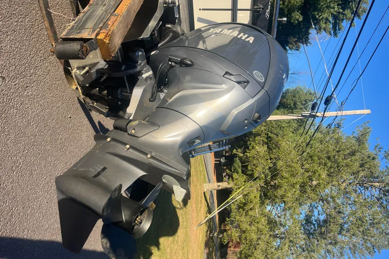 Slide: The Image of 2024 Barletta ARIA 22QC with Yamaha outboard motor on a trailer. - 11