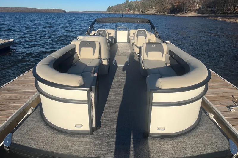 Slide: The Image of 2024 Barletta ARIA 22QC pontoon boat with spacious seating on a serene lake. - 3