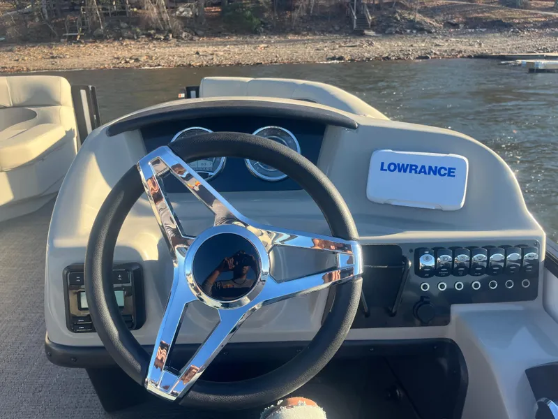 Slide: The Image of Steering wheel and dashboard of 2024 Barletta ARIA 22QC boat, featuring Lowrance electronics. - 7