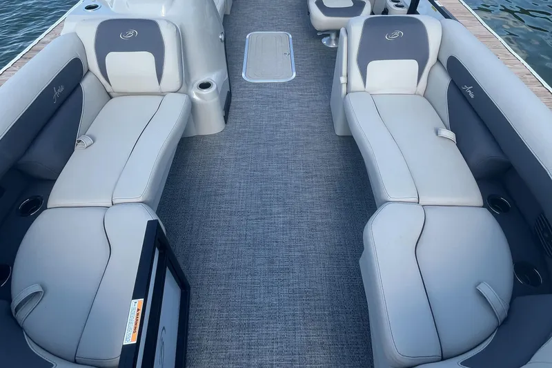 Slide: The Image of 2024 Barletta ARIA 22QC boat interior with gray seating and carpet flooring. - 8