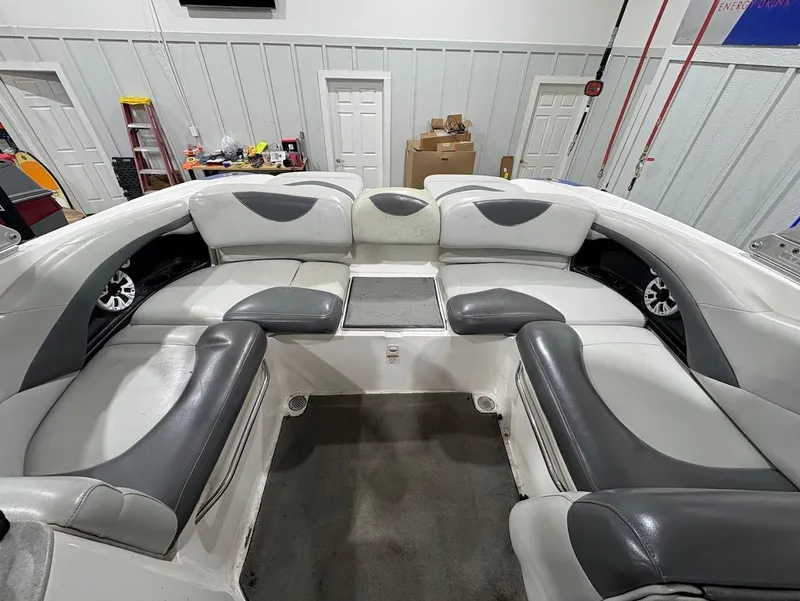 Slide: The Image of 2005 MasterCraft X-80 boat interior with gray and white seating in a garage setting. - 10