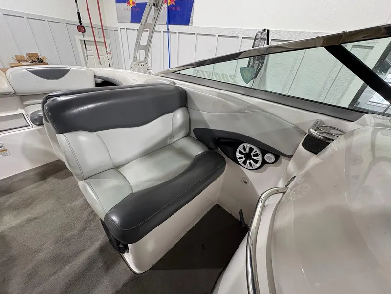 Slide: The Image of 2005 MasterCraft X-80 boat interior with gray and white seating and dashboard controls. - 15
