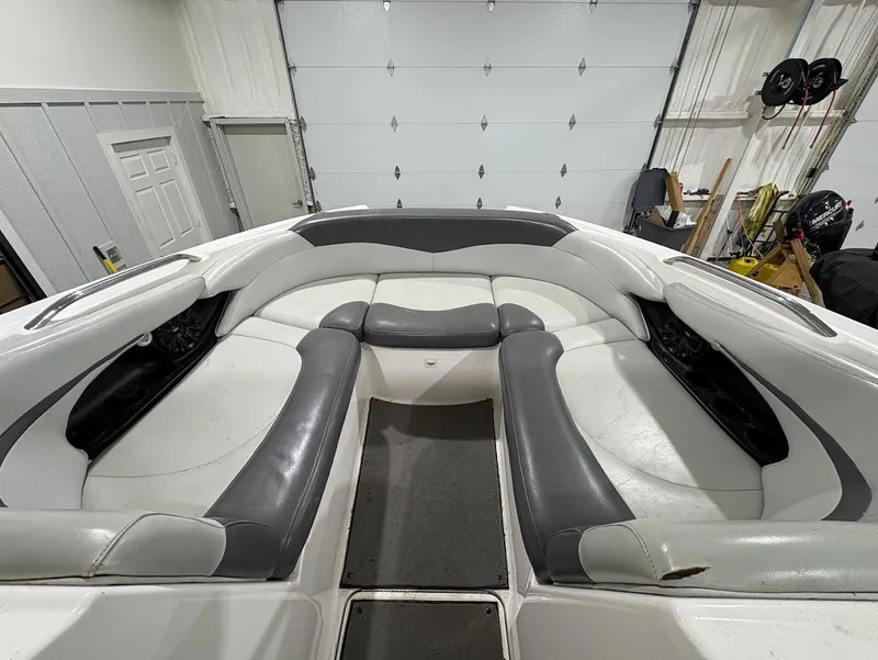 Slide: The Image of 2005 MasterCraft X-80 boat interior with white and gray seating in a garage setting. - 17