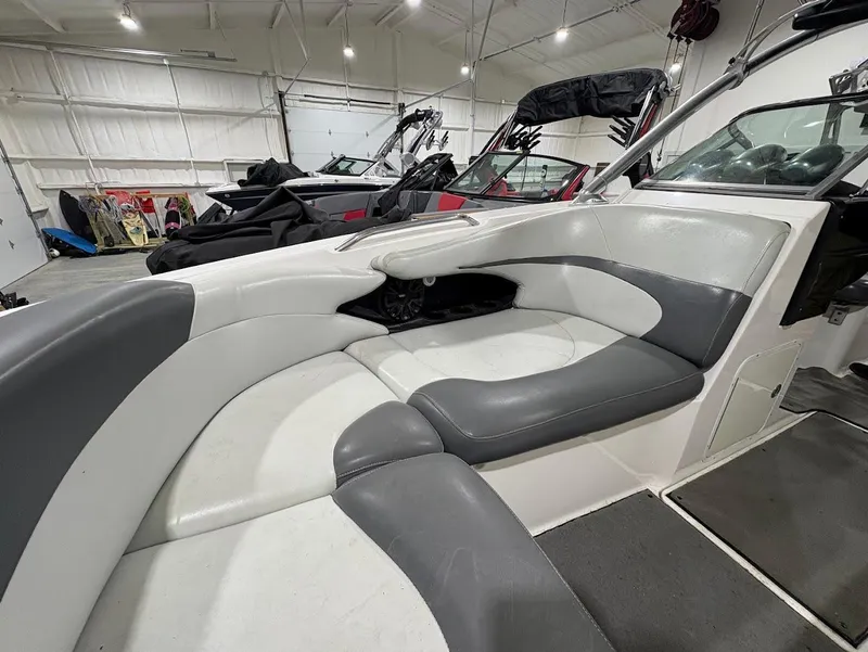Slide: The Image of 2005 MasterCraft X-80 boat interior with gray and white seating in a showroom. - 18