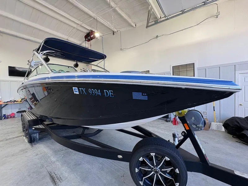 Slide: The Image of 2005 MasterCraft X-80 boat on trailer in a garage setting. - 6