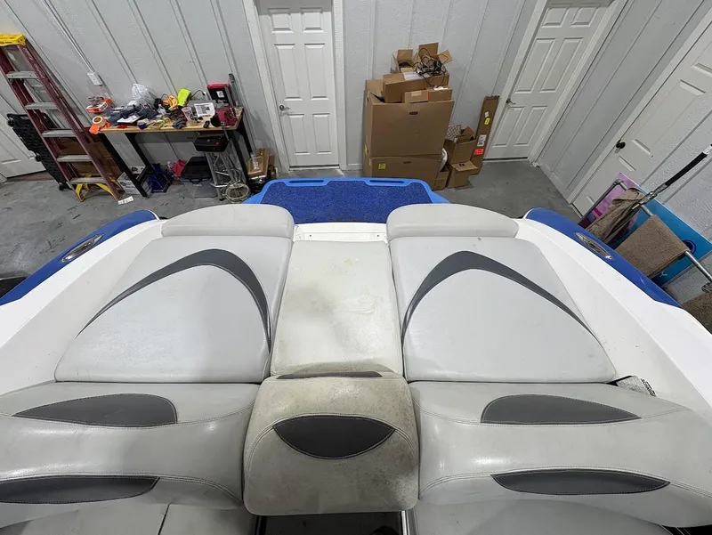 Slide: The Image of 2005 MasterCraft X-80 boat interior with gray and white seating in a garage setting. - 7