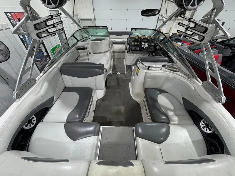 Slide: The Image of 2005 MasterCraft X-80 boat interior with gray and white seating, modern dashboard, and speaker system. - 8