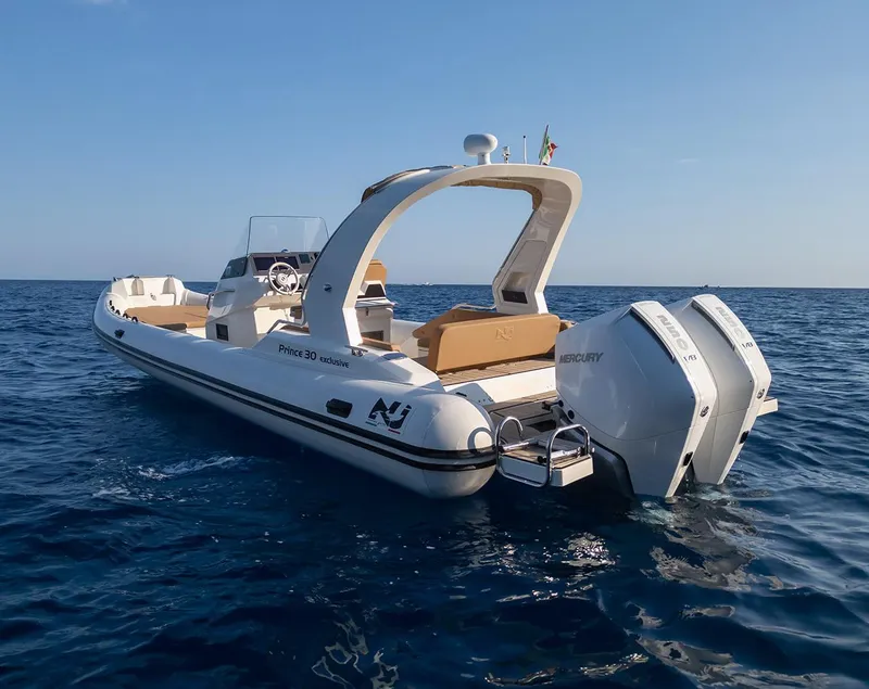 Slide: The Image of 2025 Nuova Jolly Prince 30 Exclusive boat on open water, featuring twin Mercury engines. - 10