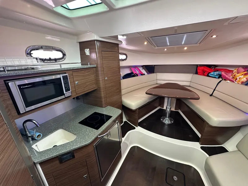 Slide: The Image of Interior of 2014 Boston Whaler 345 Conquest with kitchen and seating area. - 11