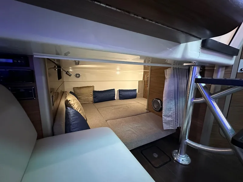 Slide: The Image of 2014 Boston Whaler 345 Conquest cabin interior with cozy seating and modern design. - 14