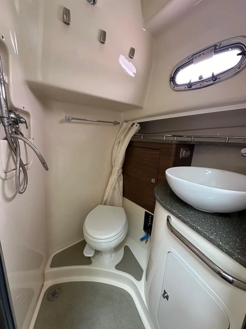 Slide: The Image of 2014 Boston Whaler 345 Conquest bathroom with modern fixtures and porthole window. - 15
