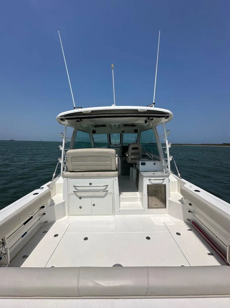 Slide: The Image of 2014 Boston Whaler 345 Conquest boat on open water, spacious deck view. - 5