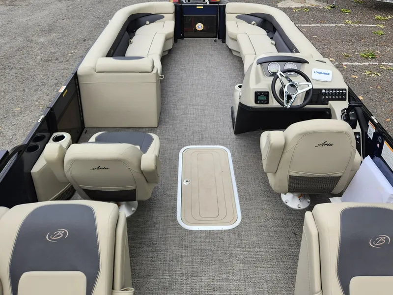 Slide: The Image of 2024 Barletta Aria 24QC pontoon boat interior with beige seating and modern helm. - 7