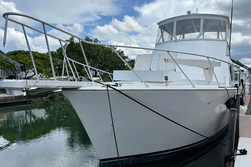 Slide: The Image of 1998 Post 50 Sportfish yacht docked, featuring sleek white design and spacious deck. - 14