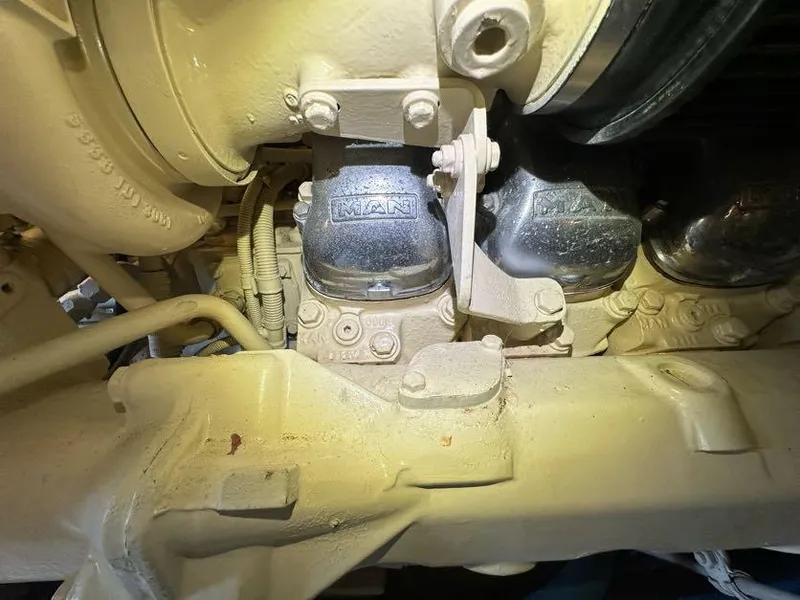 Slide: The Image of Engine components of a 1998 Post 50 Sportfish boat, featuring mechanical details and piping. - 15