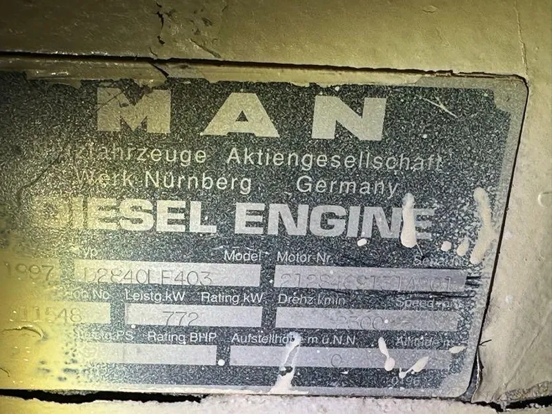 Slide: The Image of MAN diesel engine plate on 1998 Post 50 Sportfish boat, showing specifications and model details. - 18