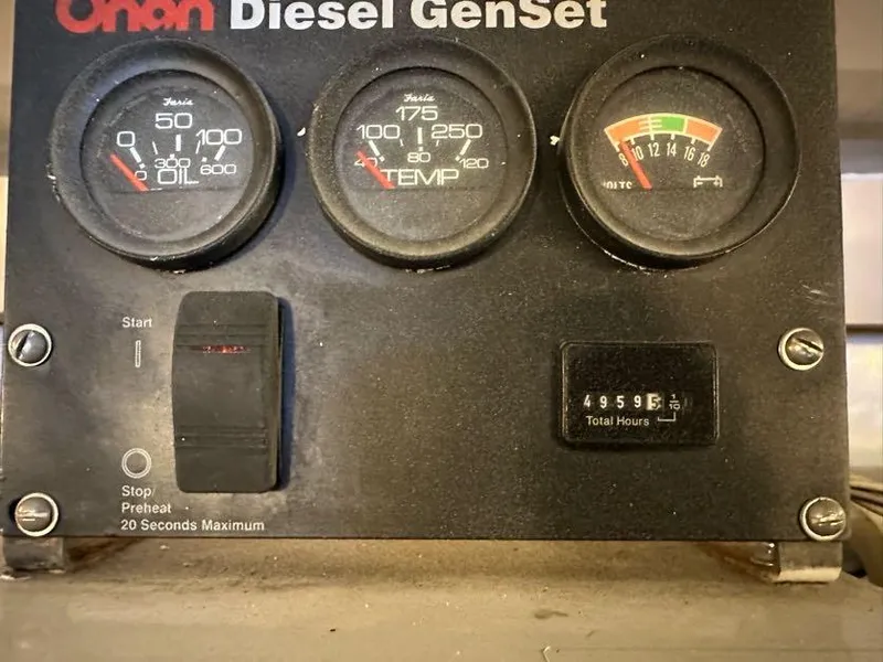 Slide: The Image of Onan Diesel GenSet control panel with gauges and hour meter, Post 50 Sportfish 1998. - 19