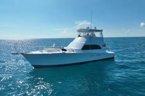 Slide: The Image of 1998 Post 50 Sportfish yacht on open ocean under clear blue sky. - 2