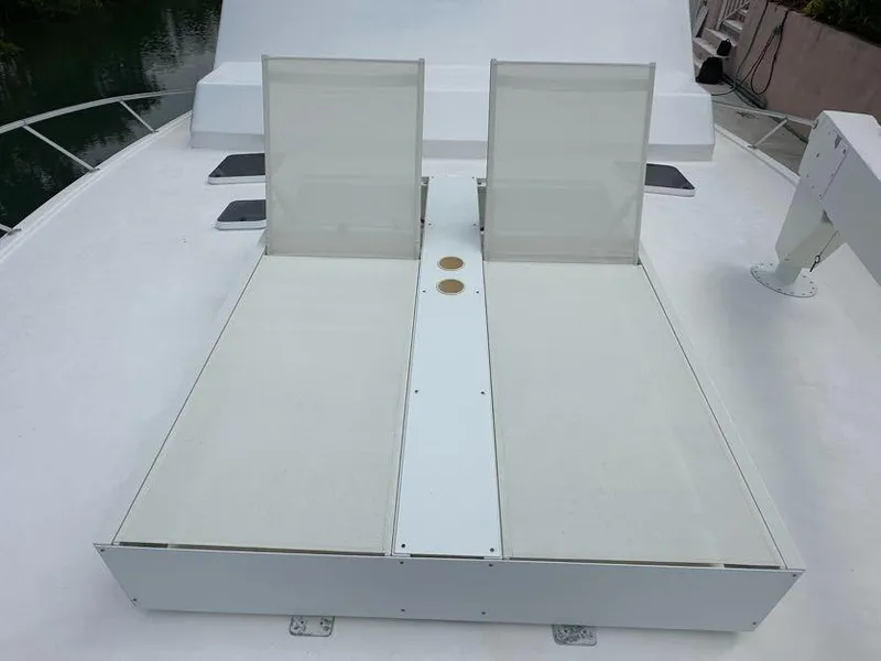 Slide: The Image of 1998 Post 50 Sportfish yacht deck with two white lounge chairs. - 20