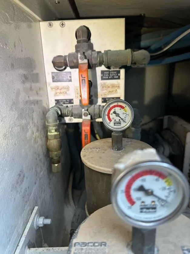 Slide: The Image of Engine room of 1998 Post 50 Sportfish with gauges and valves. - 24