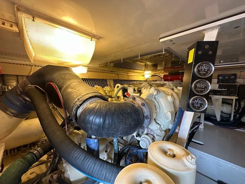 Slide: The Image of Engine room of a 1998 Post 50 Sportfish boat, featuring gauges and machinery. - 25