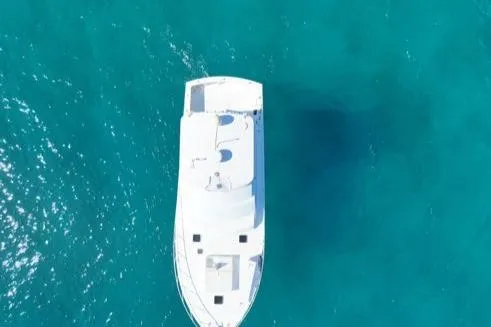 Slide: The Image of Aerial view of 1998 Post 50 Sportfish yacht on clear blue water. - 35
