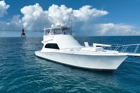 Slide: The Image of 1998 Post 50 Sportfish yacht on open sea with cloudy sky background. - 36