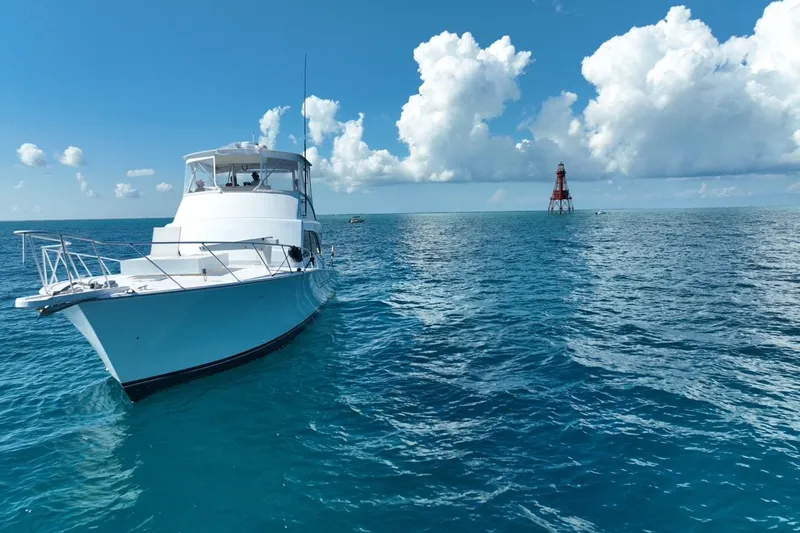Slide: The Image of 1998 Post 50 Sportfish yacht on open sea with distant lighthouse. - 39
