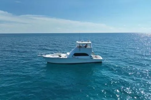 Slide: The Image of 1998 Post 50 Sportfish boat on open ocean under clear blue sky. - 41