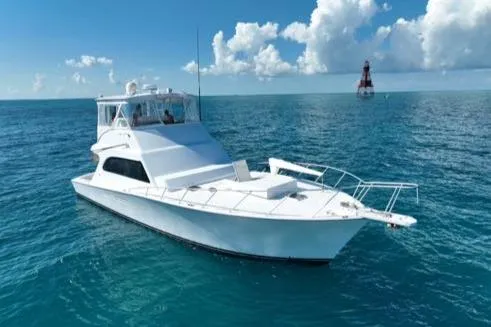 Slide: The Image of 1998 Post 50 Sportfish yacht on open sea with lighthouse in background. - 43