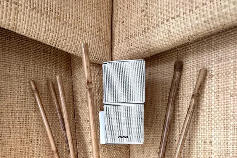 Slide: The Image of White Bose speaker on woven surface, surrounded by wooden sticks, inside a 1998 Post 50 Sportfish. - 44