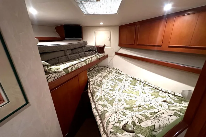 Slide: The Image of 1998 Post 50 Sportfish cabin with twin beds and wooden cabinetry. - 47