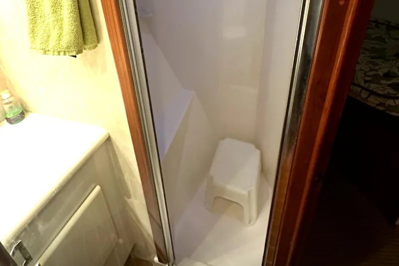 Slide: The Image of Shower area in 1998 Post 50 Sportfish boat with white stool and towel. - 49