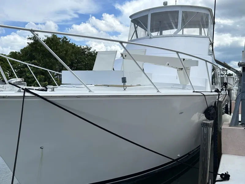 Slide: The Image of 1998 Post 50 Sportfish yacht docked, featuring sleek white design and spacious deck. - 6