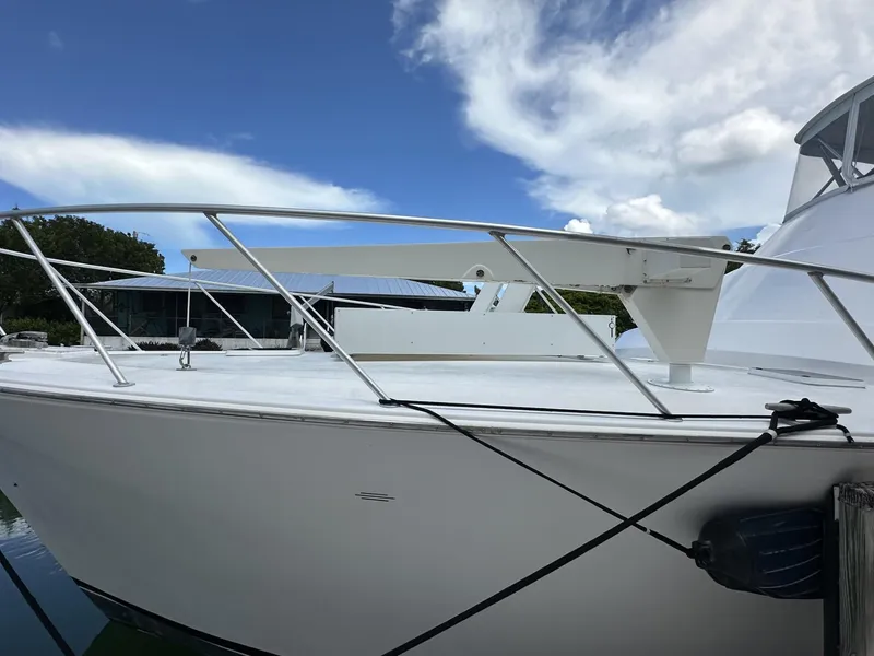 Slide: The Image of 1998 Post 50 Sportfish boat docked under a clear blue sky. - 7
