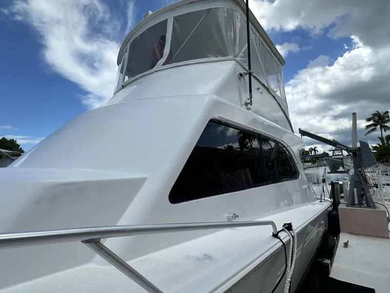 Slide: The Image of 1998 Post 50 Sportfish yacht docked under a partly cloudy sky. - 8