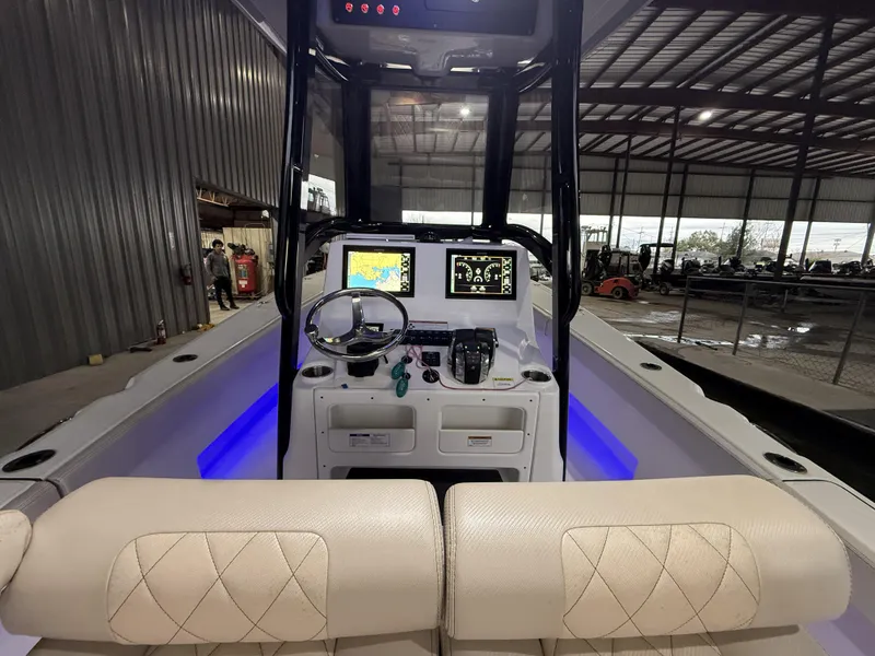 Slide: The Image of 2022 Blue Wave 2800 Makaira boat interior with modern dashboard and navigation system. - 10