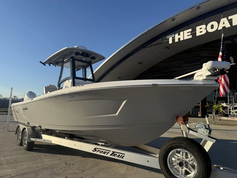 Slide: The Image of 2022 Blue Wave 2800 Makaira boat on trailer outside dealership. - 12