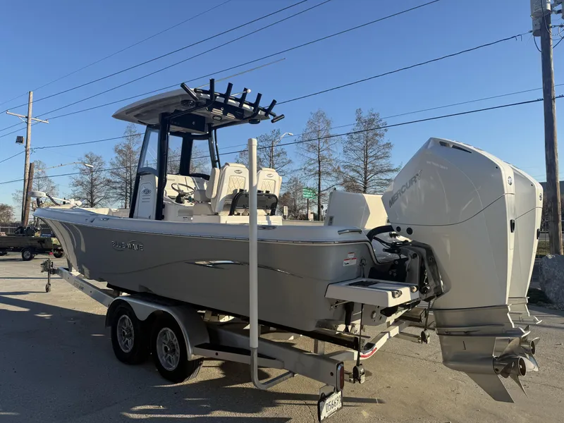 Slide: The Image of 2022 Blue Wave 2800 Makaira boat with dual Mercury engines on a trailer. - 15