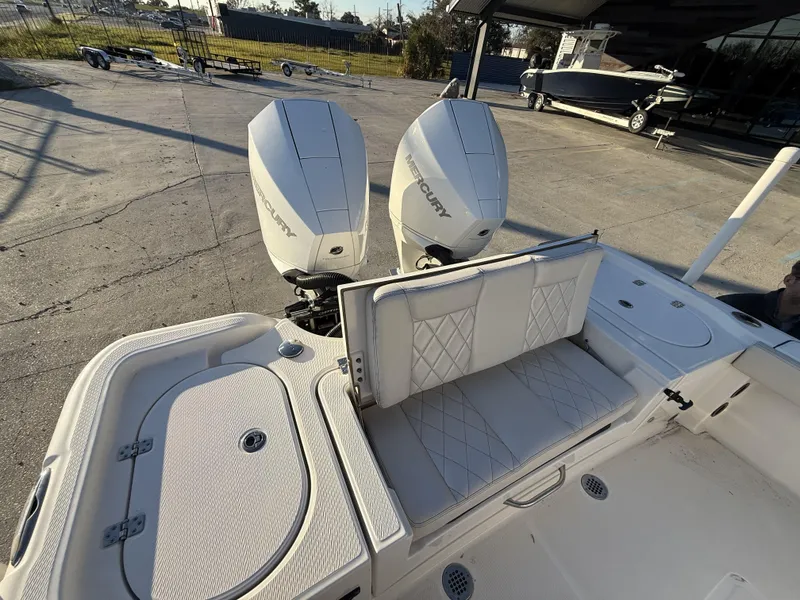 Slide: The Image of 2022 Blue Wave 2800 Makaira boat with dual Mercury engines and cushioned seating. - 25