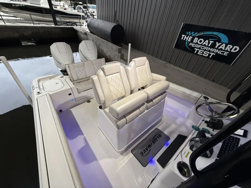 Slide: The Image of 2022 Blue Wave 2800 Makaira boat interior with luxurious seating and dual engines. - 26