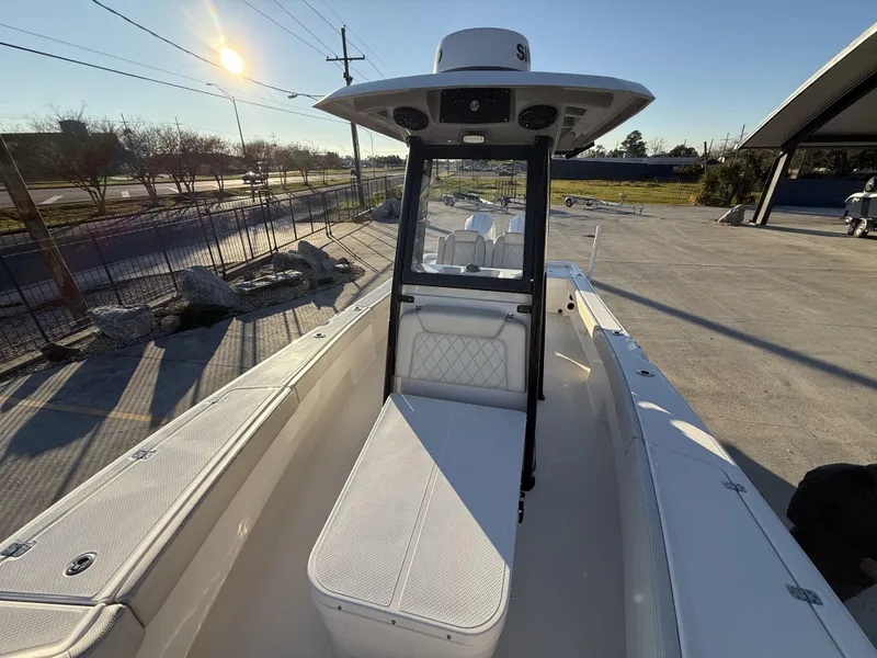Slide: The Image of 2022 Blue Wave 2800 Makaira boat, sunlit deck view, parked outdoors. - 27