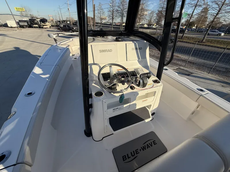 Slide: The Image of 2022 Blue Wave 2800 Makaira boat interior with steering console and Simrad electronics. - 3