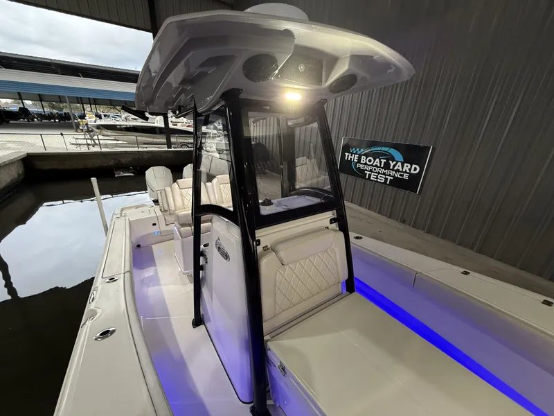 Slide: The Image of 2022 Blue Wave 2800 Makaira boat interior with illuminated seating and performance test sign. - 6